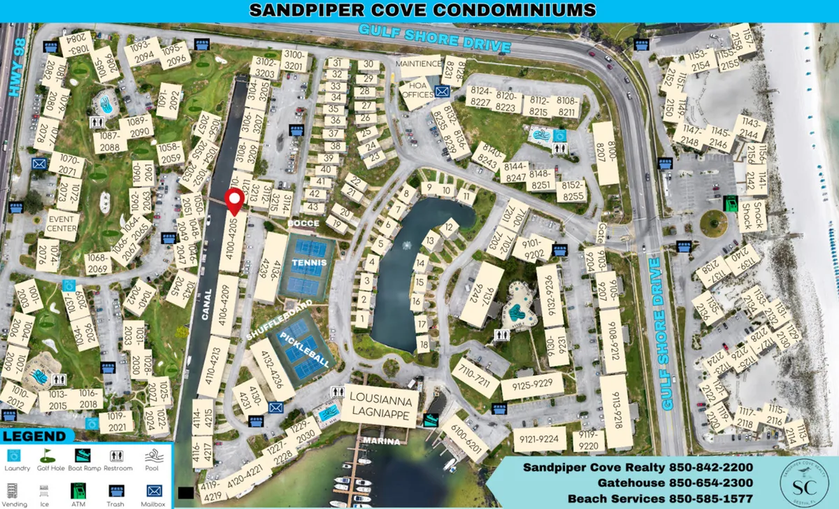 This wide exterior shot captures the vibrant heart of Sandpiper Cove with its recreational courts (tennis, pickleball, shuffleboard), nearby canal with boats, and an array of condominium buildings. The image also hints at the proximity to the private beach and onsite dining, showing landscaped pathways and an inviting community atmosphere.